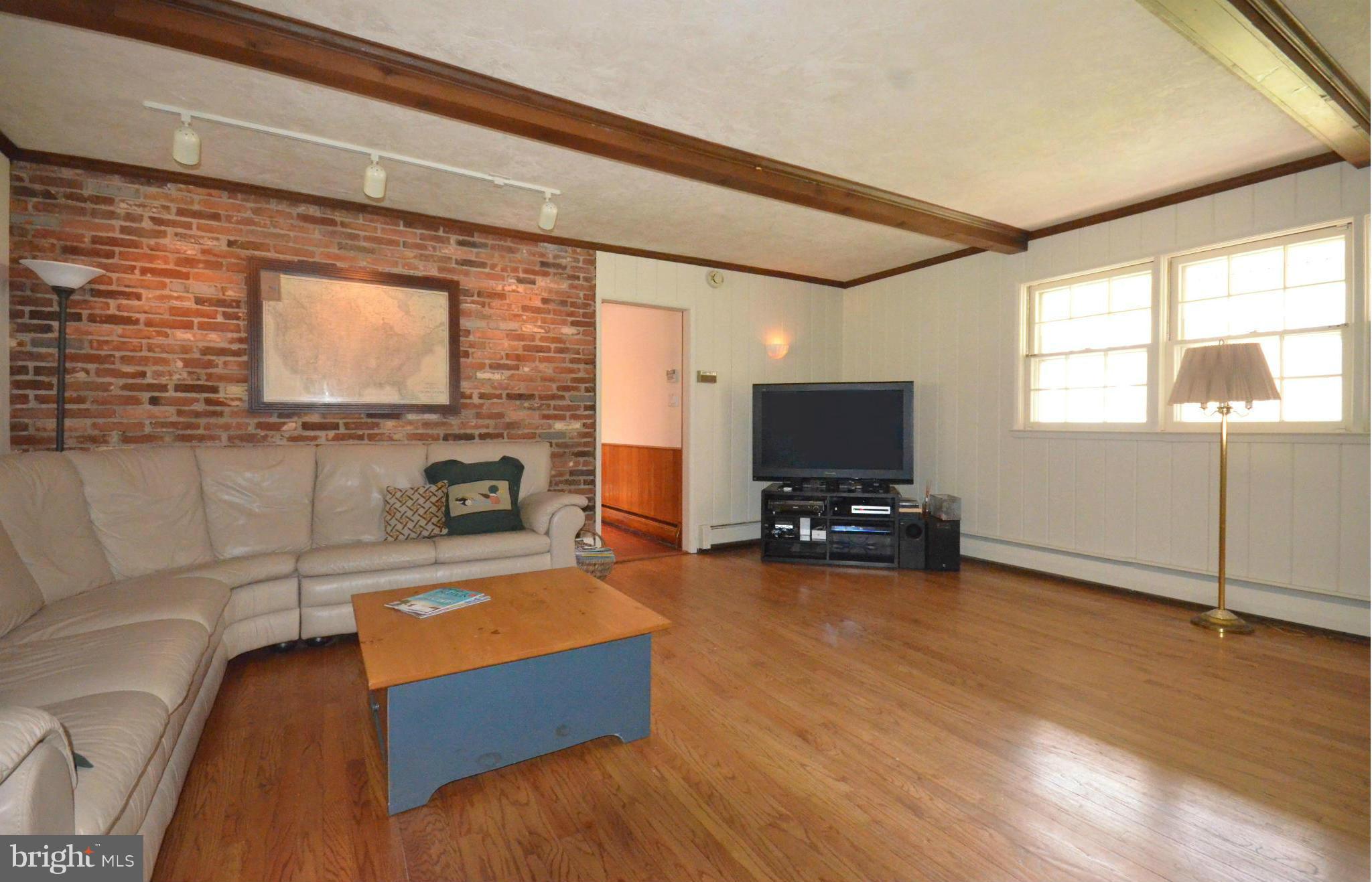 2406 Pot Spring Road Lutherville-Timonium, MD 21093 - Photo 14 of 30 Family Room wood flooring and exit to porch