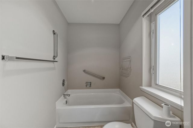 a bathroom with a bathtub and window