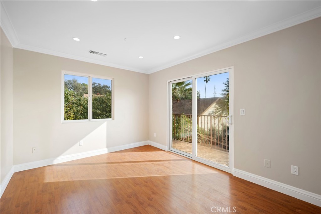 6541 Elmo Street Tujunga, CA 91042 - Photo 14 of 20 a view of an empty room with wooden floor and a window