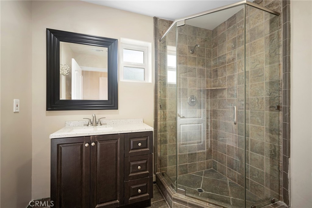 6541 Elmo Street Tujunga, CA 91042 - Photo 17 of 20 a bathroom with a shower and a sink mirror