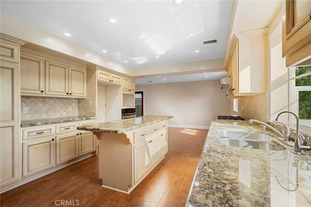 6541 Elmo Street Tujunga, CA 91042 - Photo 6 of 20 a kitchen with a stove sink and cabinets
