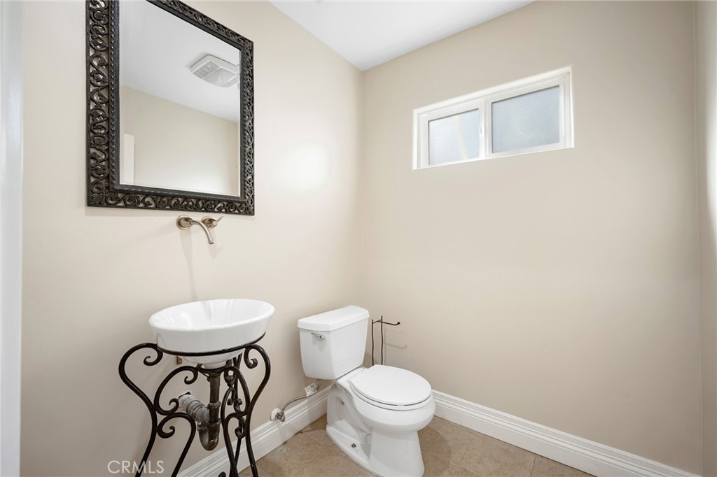 6541 Elmo Street Tujunga, CA 91042 - Photo 7 of 20 a bathroom with a toilet a sink and mirror