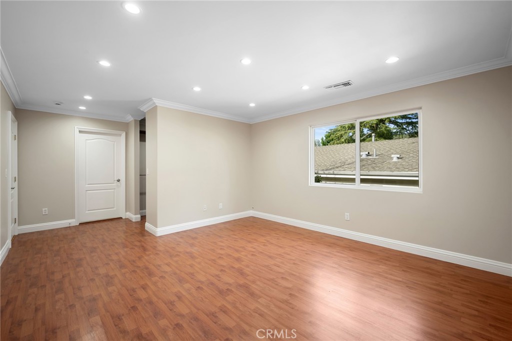 6541 Elmo Street Tujunga, CA 91042 - Photo 10 of 20 an empty room with wooden floor and window