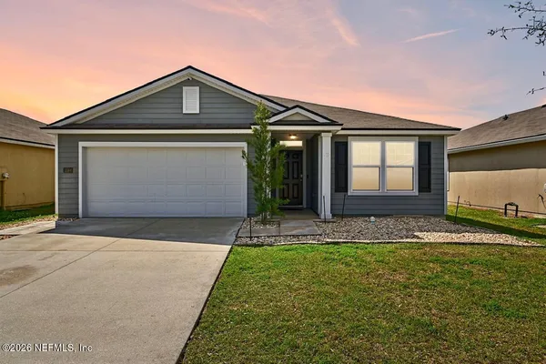 a front view of a house with a yard and garage