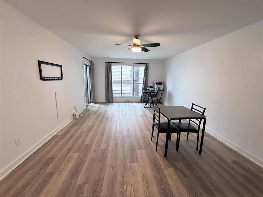 4837 Cedar Springs Road, Unit 110 Dallas, TX 75219 - Photo 11 of 21 a furnished livingroom with windows and wooden floor