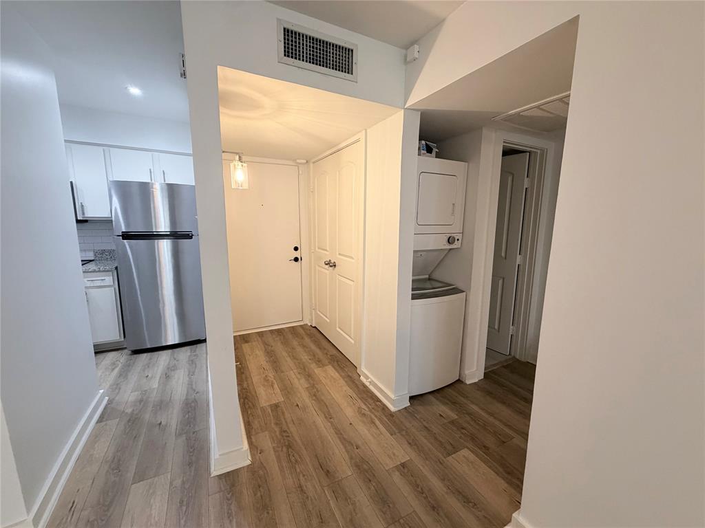 4837 Cedar Springs Road, Unit 110 Dallas, TX 75219 - Photo 12 of 21 a view of a kitchen from a hallway
