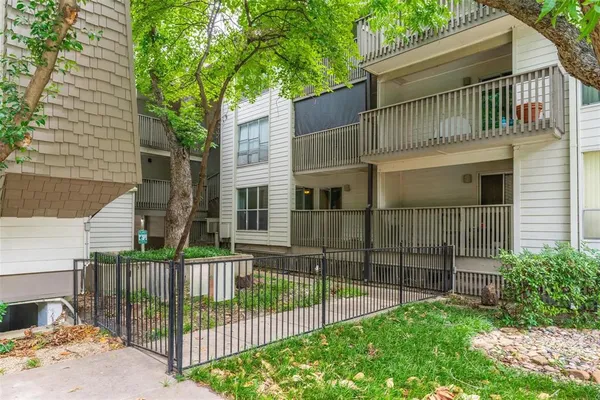 a view of a house with a wooden fence