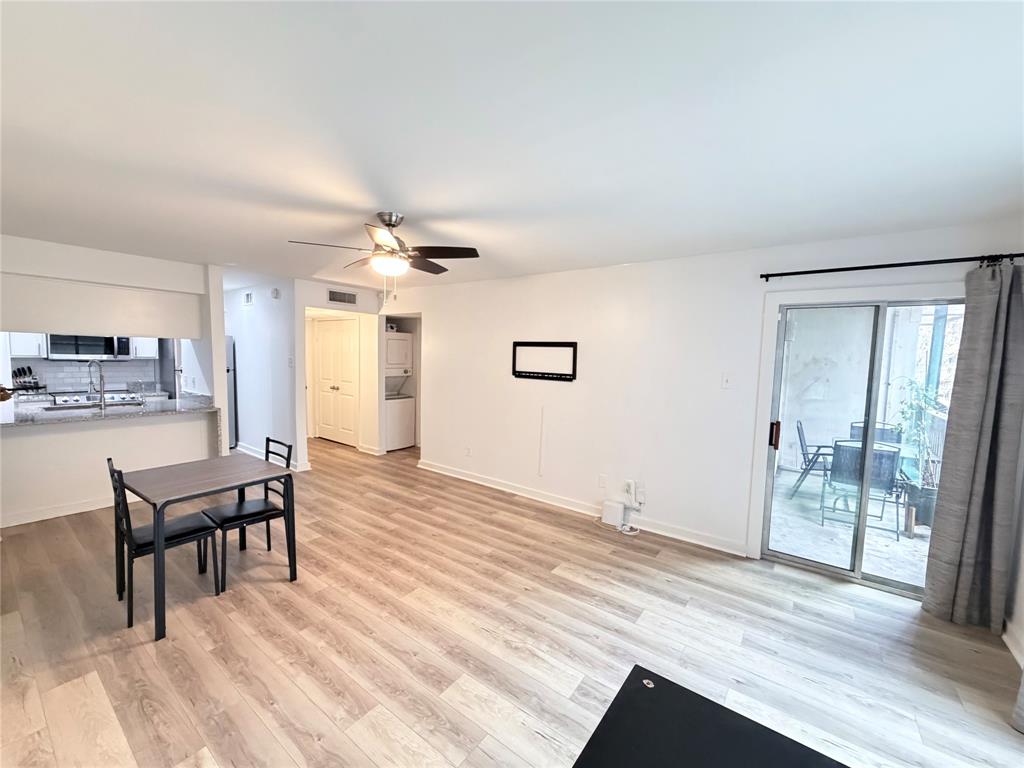 4837 Cedar Springs Road, Unit 110 Dallas, TX 75219 - Photo 3 of 21 a view of a livingroom with furniture and wooden floor