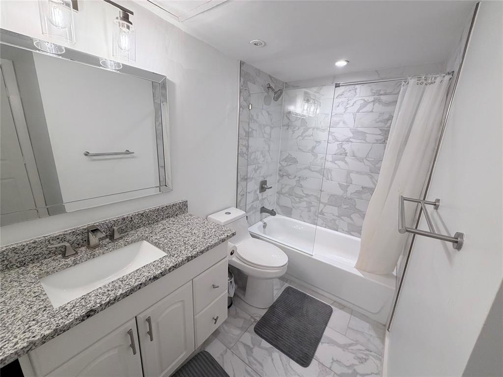 4837 Cedar Springs Road, Unit 110 Dallas, TX 75219 - Photo 5 of 21 a bathroom with a granite countertop sink toilet and shower