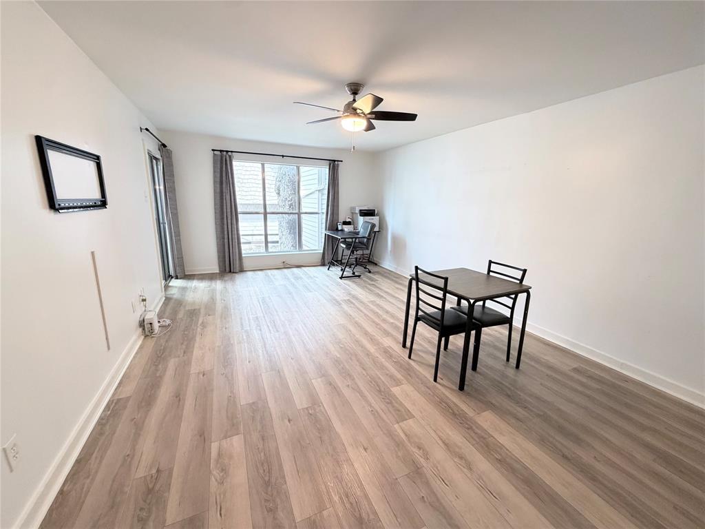 4837 Cedar Springs Road, Unit 110 Dallas, TX 75219 - Photo 7 of 21 a view of a livingroom with furniture and hardwood floor