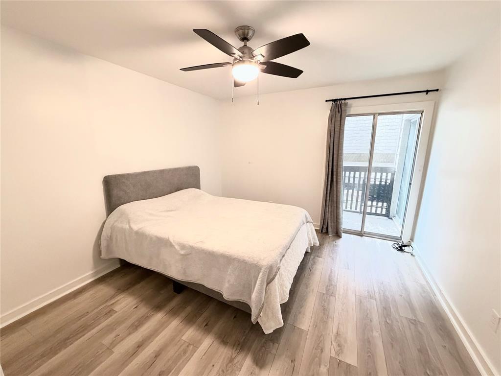 4837 Cedar Springs Road, Unit 110 Dallas, TX 75219 - Photo 8 of 21 a bedroom with a bed and window