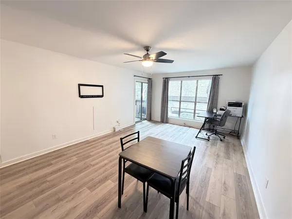 a view of a workspace with furniture and a window