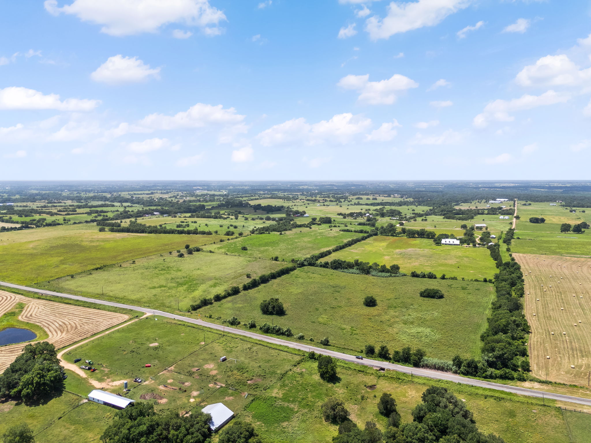 0 Thielemann Road Industry, TX 78944 - Photo 22 of 40 An expansive rural landscape unfurls beneath a wide-open sky, offering serene countryside living.