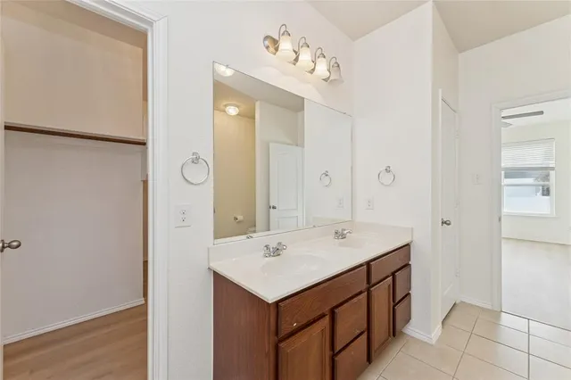 a bathroom with a sink vanity and mirror