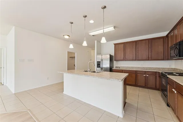 a kitchen with kitchen island a counter top space appliances and cabinets