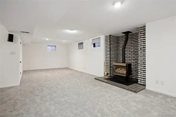 a view of an empty room with a fireplace