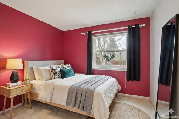 a bedroom with a bed and a large window