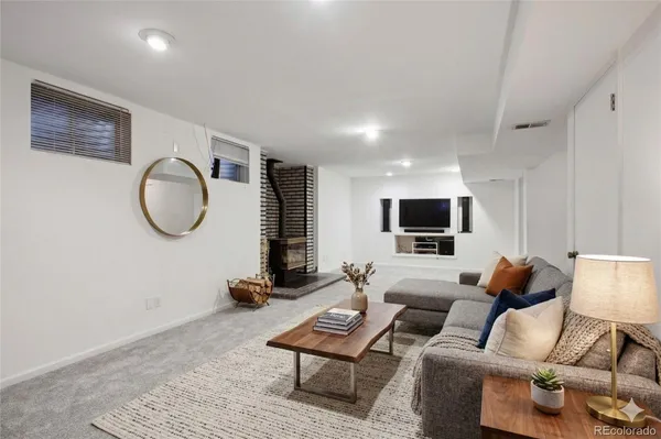 a living room with furniture a rug and a flat screen tv