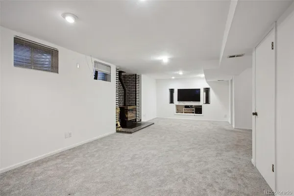 a view of an empty room with a painting on the wall