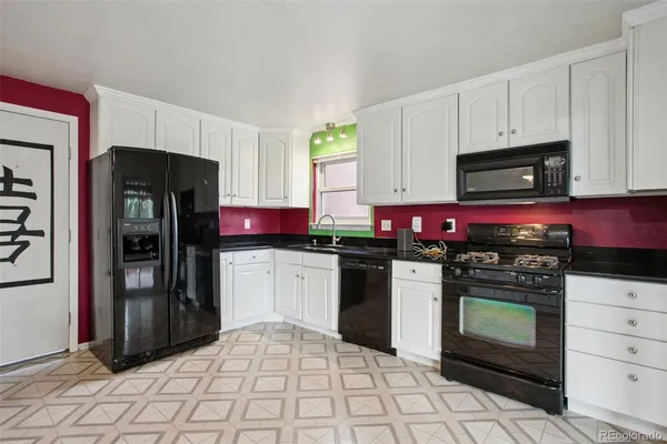 a kitchen with stainless steel appliances granite countertop a stove refrigerator and microwave