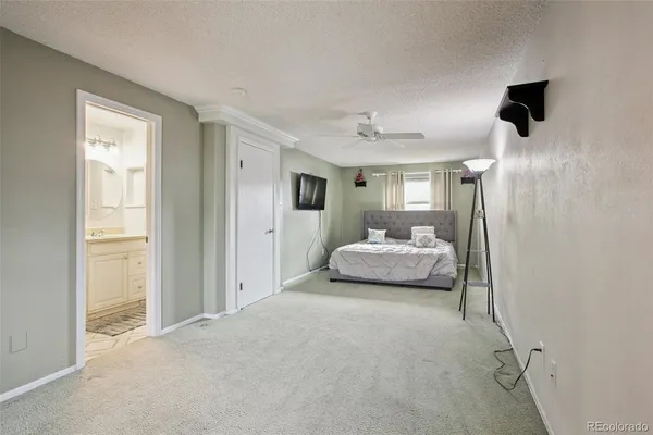 a bedroom with a bed and a mirror