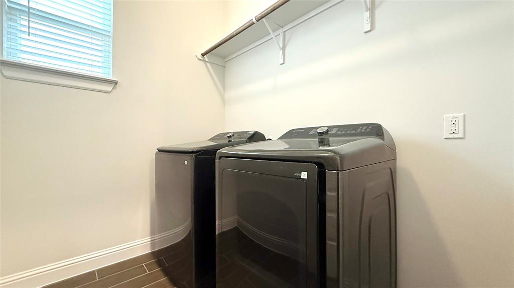 601 C-Bar Ranch Trail, Unit 27 Cedar Park, TX 78613 - Photo 27 of 29 Laundry area featuring wood-finish tile flooring, a window with blinds, and a built-in overhead shelf with a hanging rod