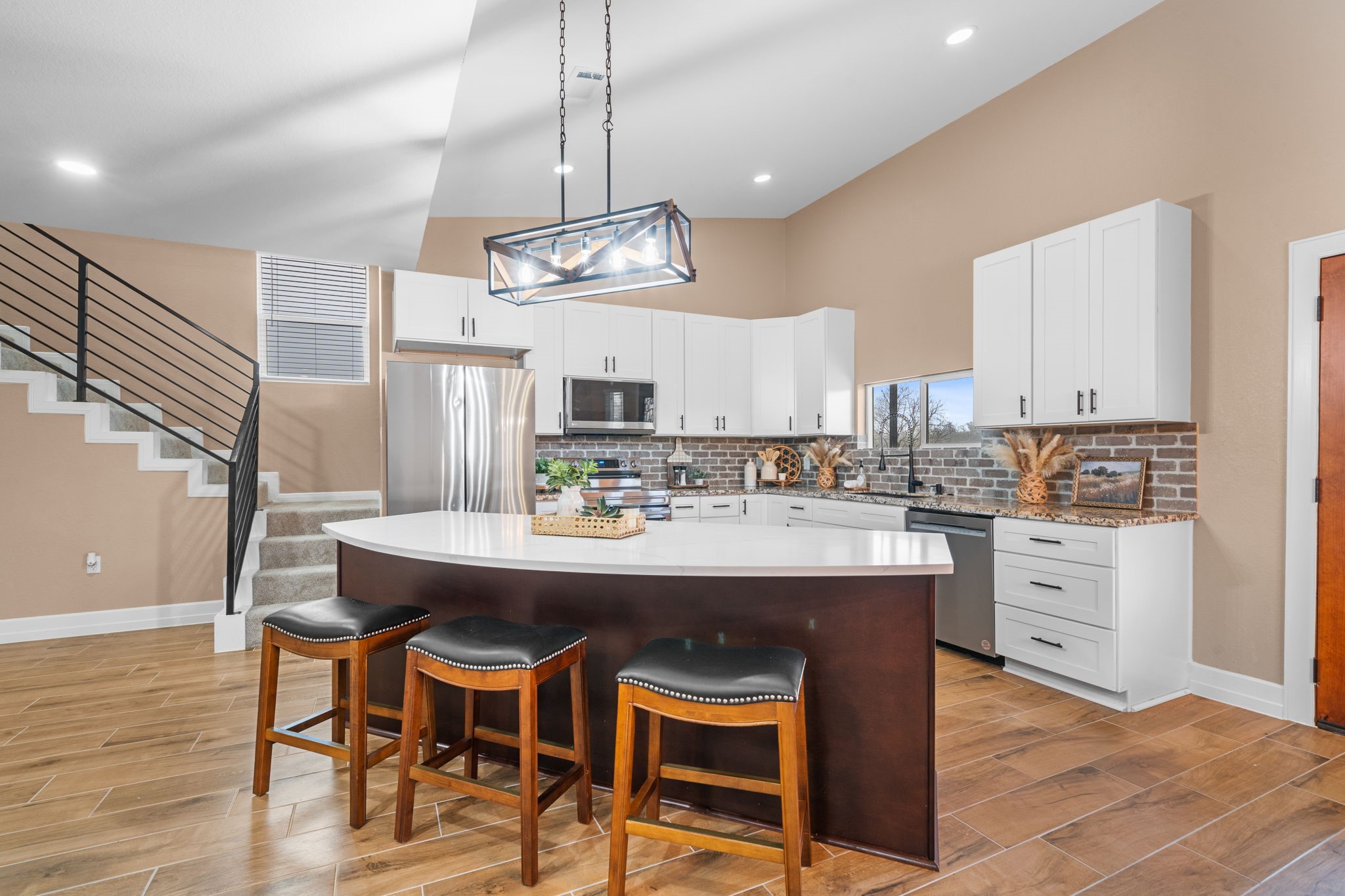 4011 County Road 219 Anderson, TX 77830 - Photo 11 of 38 a kitchen with stainless steel appliances kitchen island granite countertop a table chairs and white cabinets