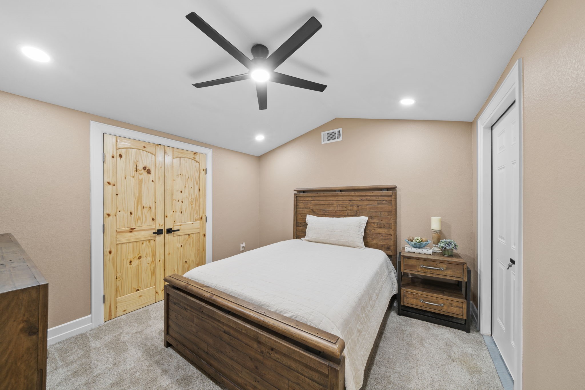 4011 County Road 219 Anderson, TX 77830 - Photo 25 of 38 a bedroom with a large bed and a chandelier