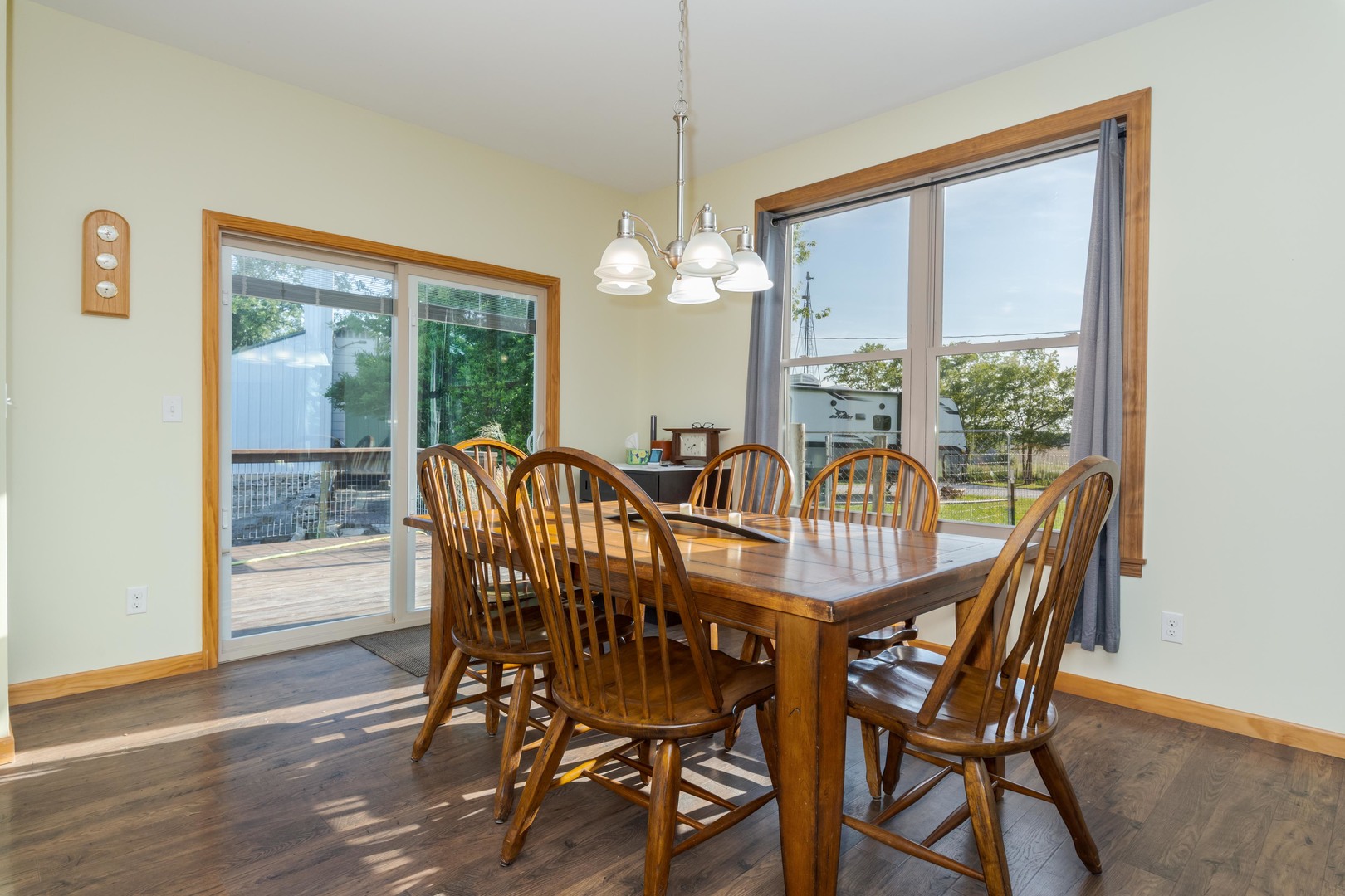 22037 East 2600 N Road Odell, IL 60460 - Photo 20 of 59 a view of a dining room with furniture large windows a chandelier and wooden floor