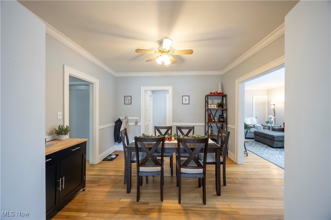2075 Coventry Road Cleveland, OH 44118 - Photo 18 of 41 Dining area featuring ceiling fan, crown molding, and light hardwood / wood-style floors