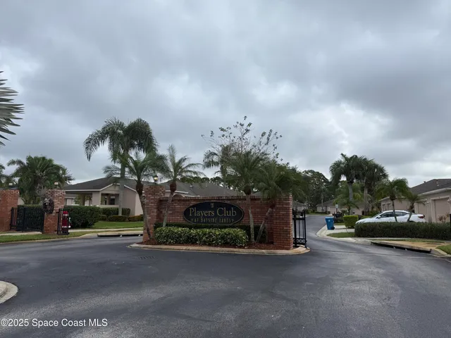 a front view of a house with a garden and parking