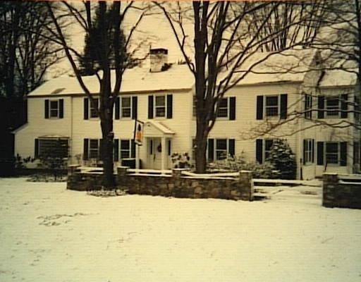 144 Good Hill Road Weston, CT 06883 - Photo 1 of 1 a front view of a house with a yard covered with snow in front of house