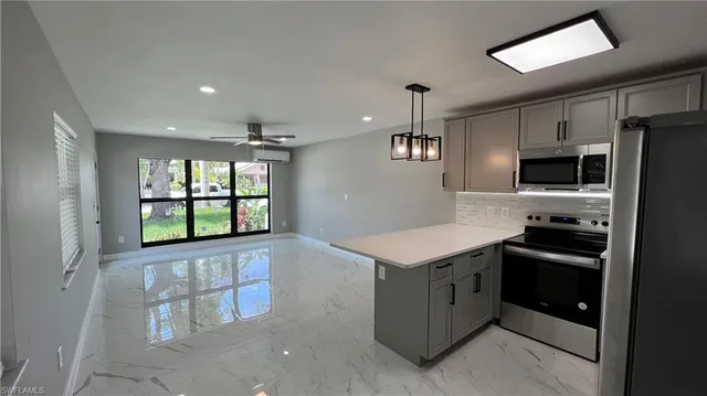 a kitchen with a stove a sink and a refrigerator