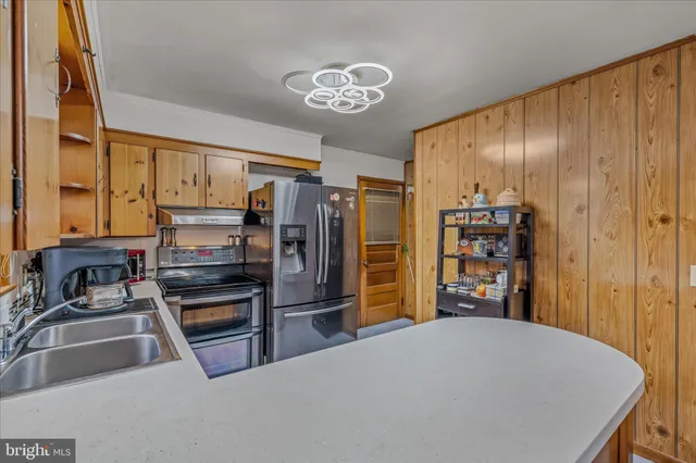 a kitchen with stainless steel appliances a refrigerator and a sink