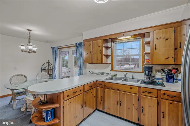 a kitchen with stainless steel appliances granite countertop a sink dishwasher and cabinets with wooden floor