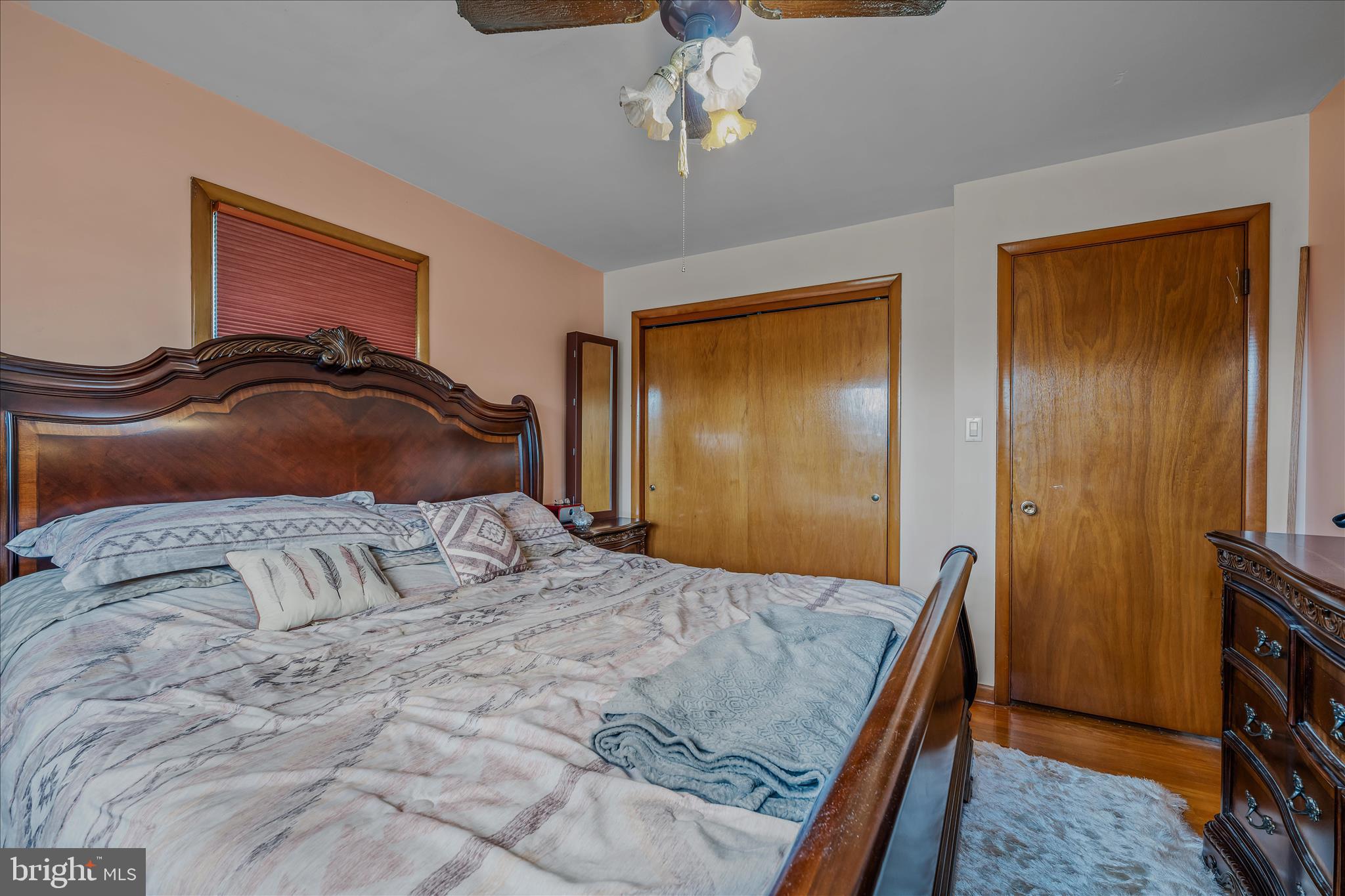 1635 Fairview Drive Berkeley Springs, WV 25411 - Photo 16 of 45 a bedroom with a bed and a chandelier