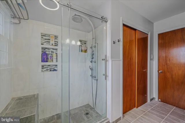 a bathroom with a shower and a sink