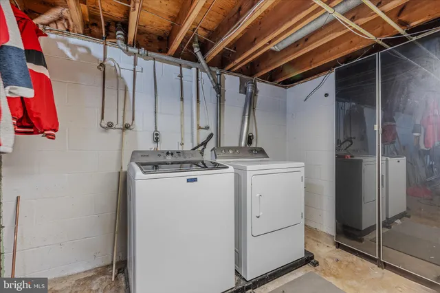 a view of storage and utility room with washer and dryer