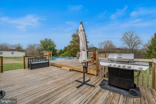 a view of a roof deck with chair and wooden floor