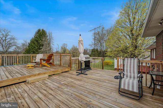 a view of a roof deck with wooden floor and seating