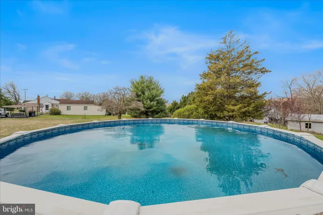 a view of a swimming pool and an outdoor seating