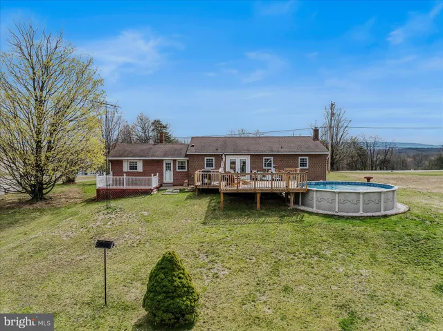 a view of a house with backyard porch and sitting area