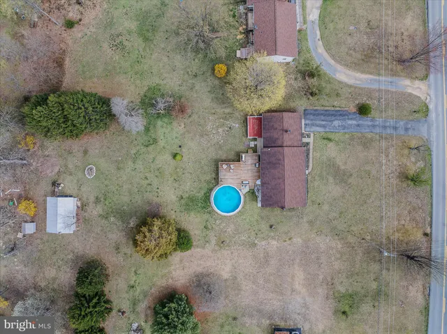 an aerial view of a house with a backyard