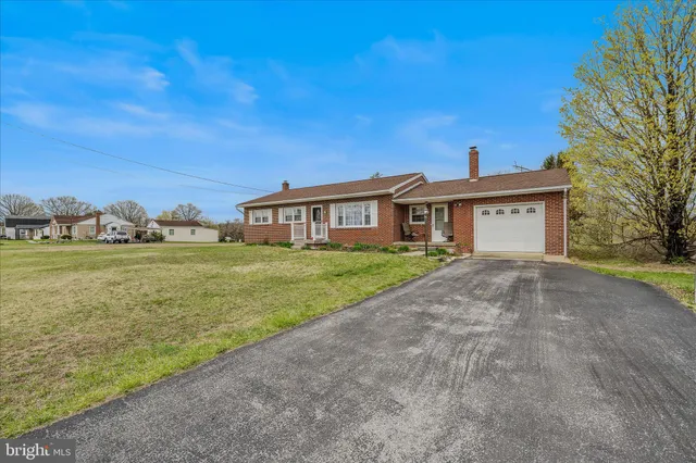 a view of house with yard and ocean view