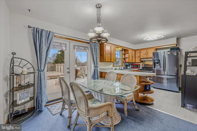 a dining room with furniture a chandelier and window