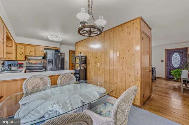 a view of a dining room with furniture wooden floor and chandelier