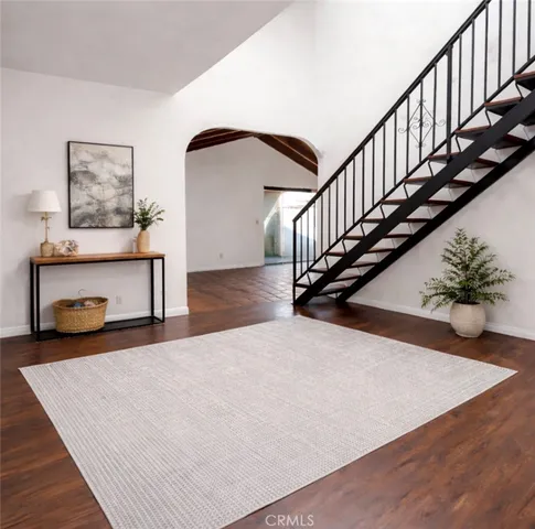 a view of staircase with wooden floor and white walls