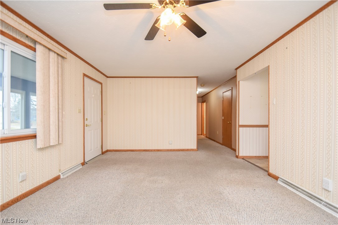 4606 Burkey Road Youngstown, OH 44515 - Photo 10 of 49 Carpeted spare room with ornamental molding and ceiling fan