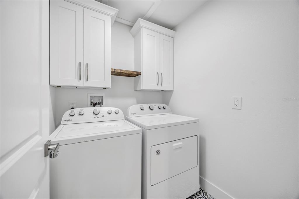 11728 Raintree Drive Temple Terrace, FL 33617 - Photo 24 of 41 a view of storage and utility room with washer and dryer