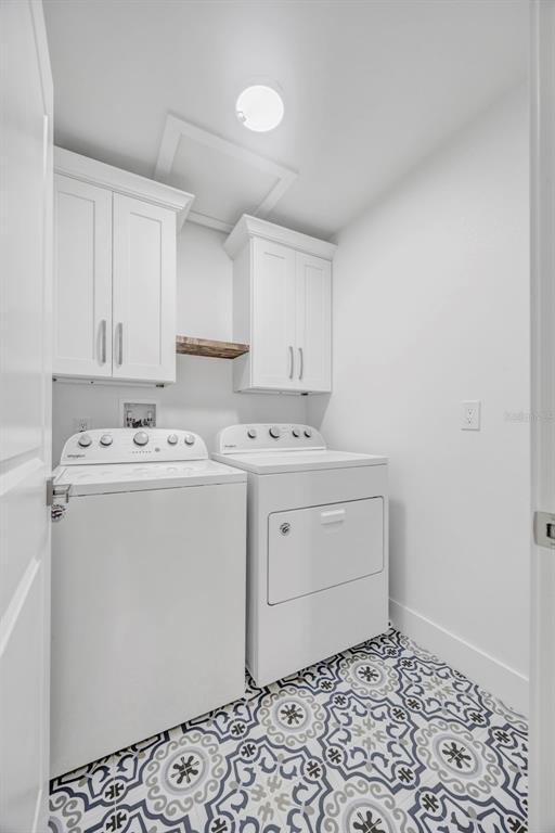 11728 Raintree Drive Temple Terrace, FL 33617 - Photo 25 of 41 a utility room with cabinets washer and dryer